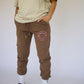 Model wearing Happy Home chocolate sweatpants — founder-owned streetwear supports NAMI