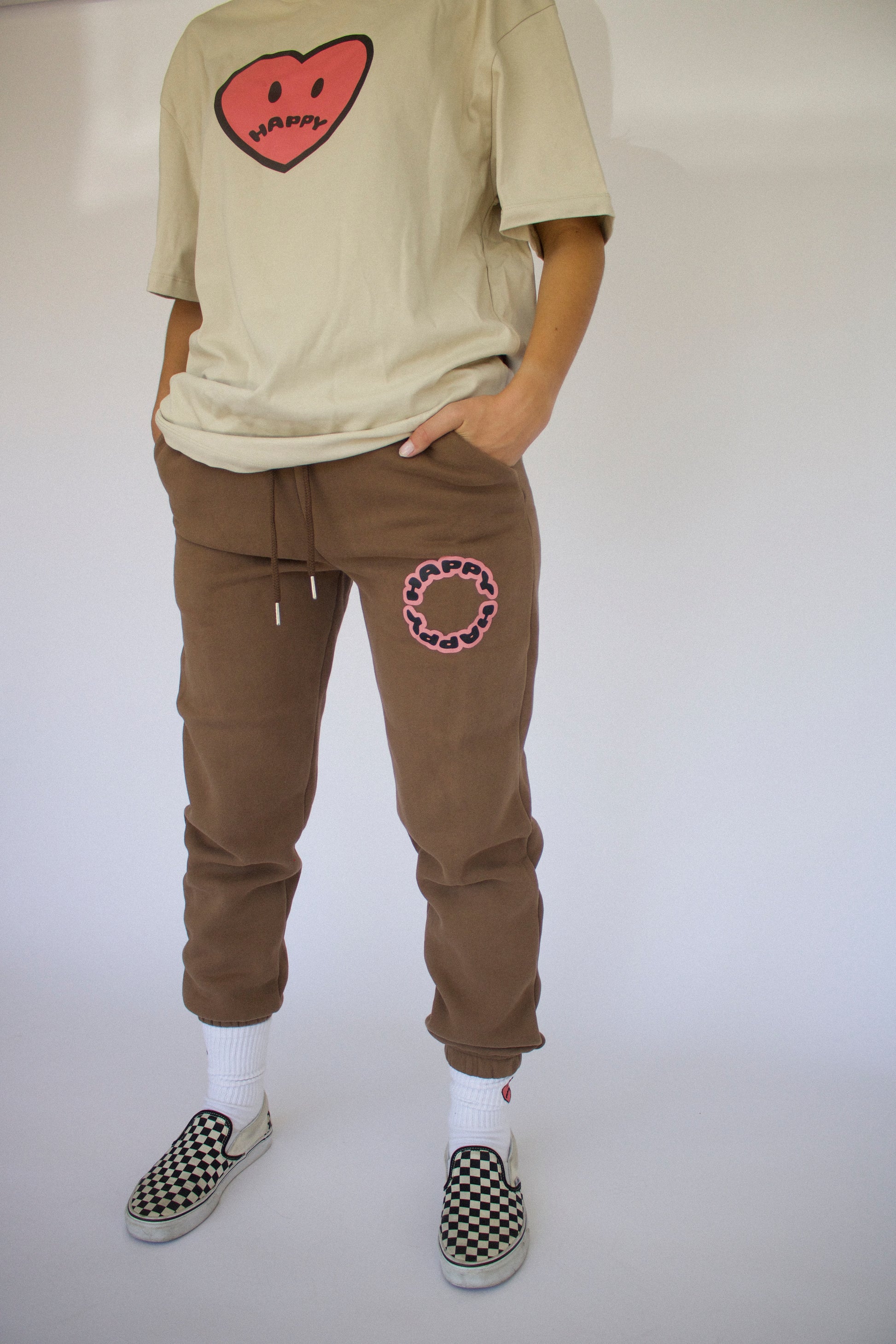 Model wearing Happy Home chocolate sweatpants — founder-owned streetwear supports NAMI