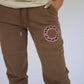 Happy Home centerpiece sweatpants chocolate lifestyle — brand that turns pain into purpose