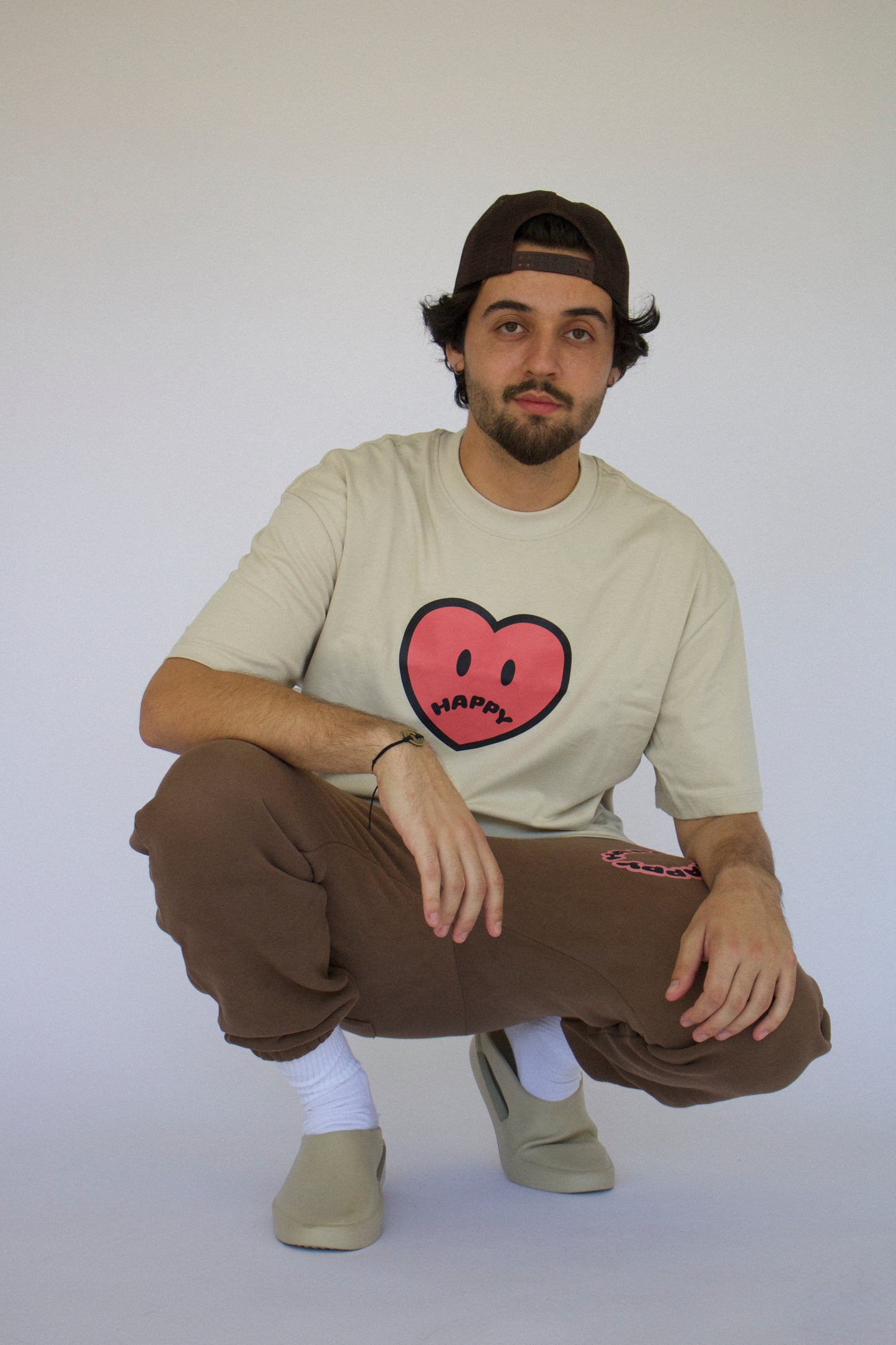 Happy Home centerpiece tee sand lifestyle — streetwear brand that supports NAMI