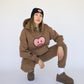 Happy Home centerpiece hoodie chocolate lifestyle — brand that turns pain into purpose