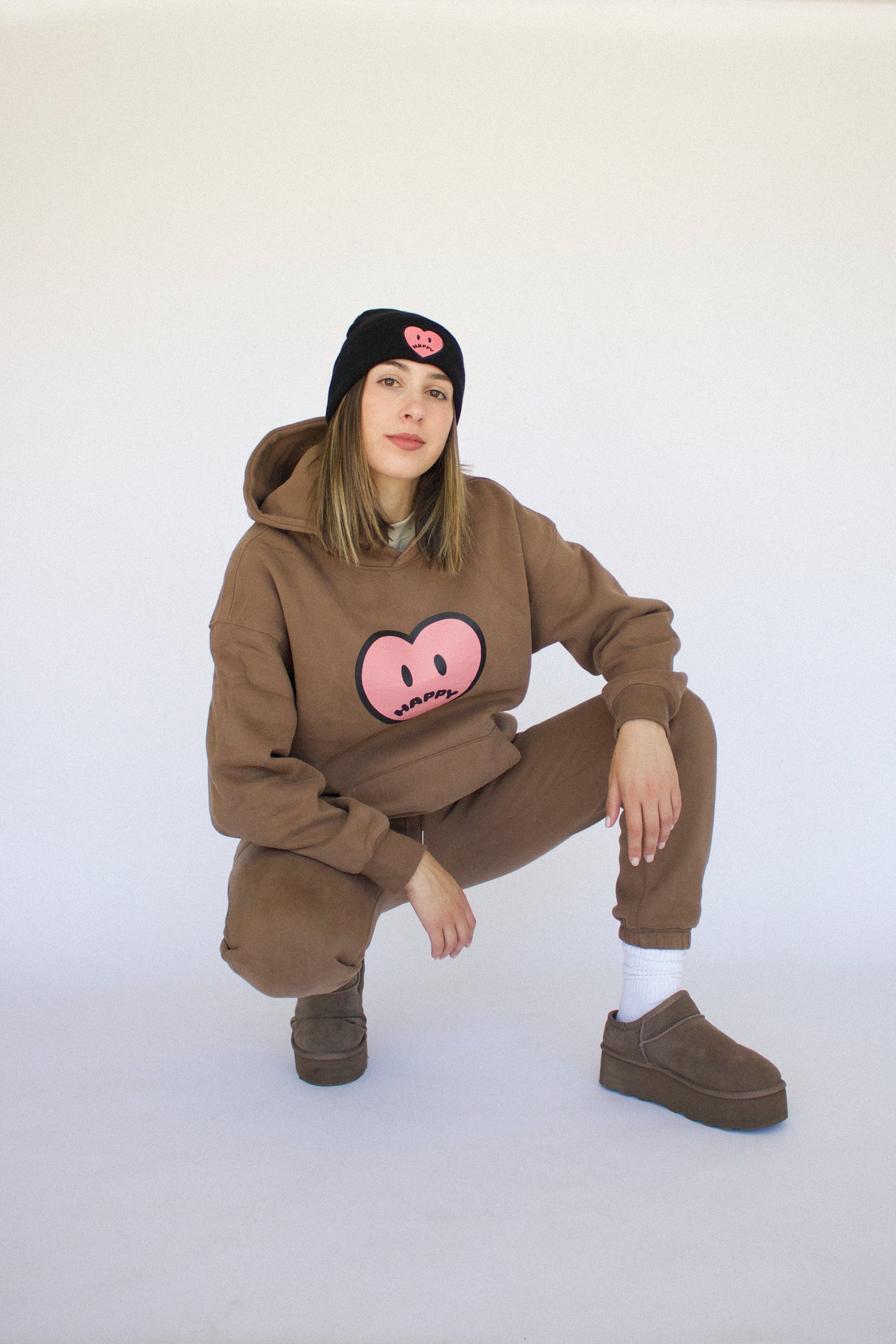 Happy Home centerpiece hoodie chocolate lifestyle — brand that turns pain into purpose