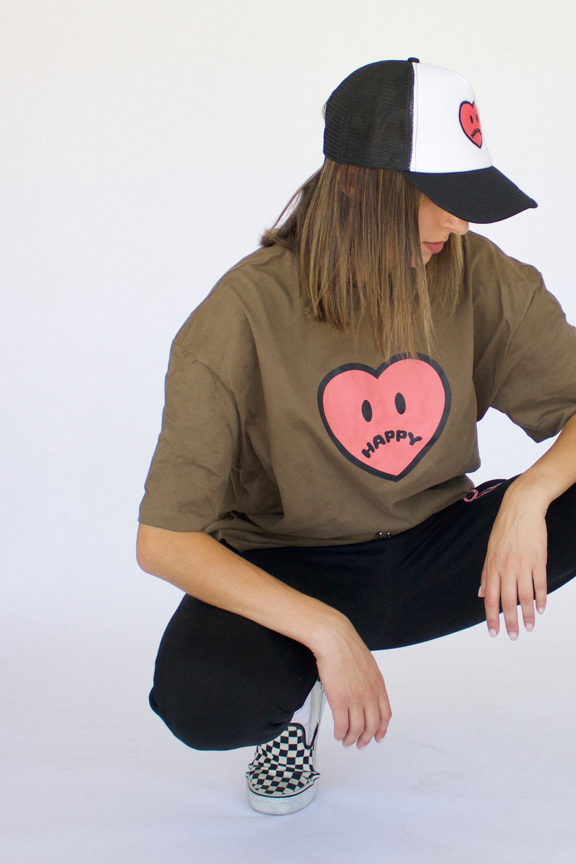 Model wearing Happy Home jet black trucker hat — founder-owned mental health streetwear