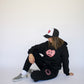 Model wearing Happy Home jet black sweatpants — founder-owned streetwear supports NAMI