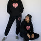 Model wearing Happy Home jet black hoodie — limited 240-piece drop streetwear brand