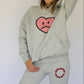 Model wearing Happy Home heather gray sweatpants — founder-owned streetwear supports NAMI