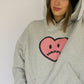 Happy Home heather gray hoodie on model — limited 240-piece drop earthy colorway