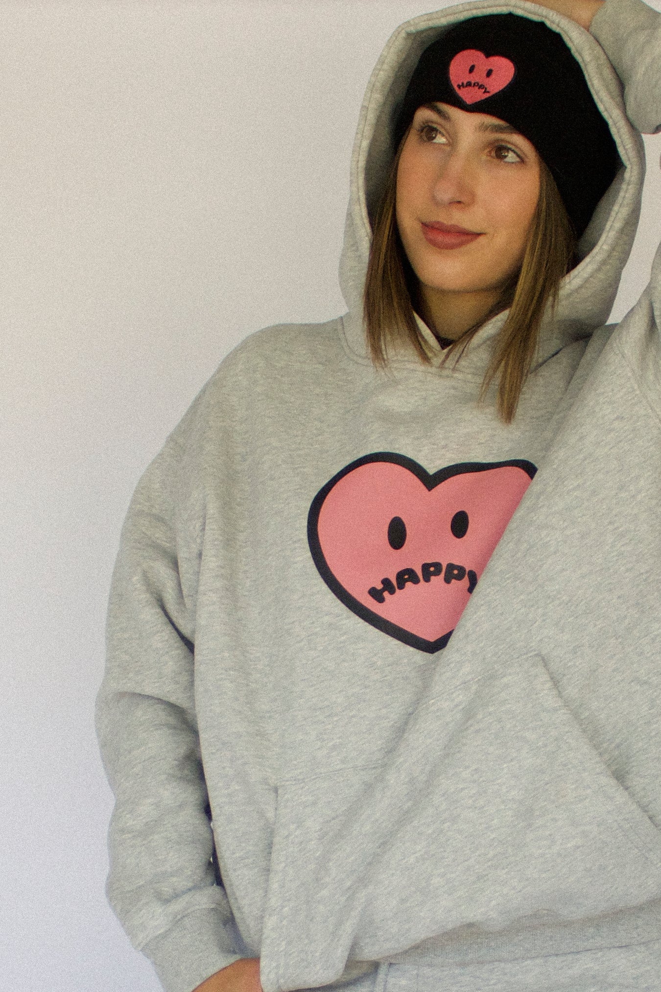 Happy Home heather gray hoodie on model — limited 240-piece drop earthy colorway