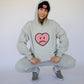 Happy Home centerpiece hoodie heather gray lifestyle — mental health streetwear with a cause