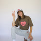 Happy Home centerpiece tee wood lifestyle — brand that turns pain into purpose