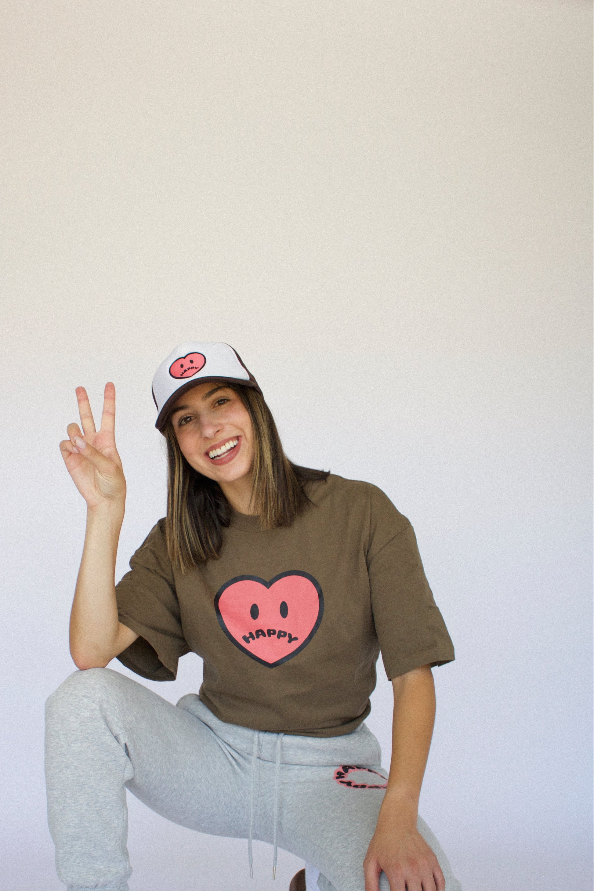 Happy Home centerpiece trucker hat chocolate lifestyle — earthy streetwear brand with a cause