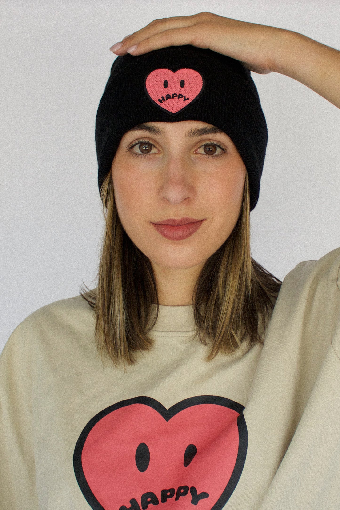 Happy Home centerpiece beanie on model — founder-owned clothing brand supports NAMI