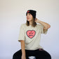 Happy Home sand tee on model — limited drop earthy colorway streetwear