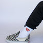 Model wearing Happy Home centerpiece socks — founder-owned streetwear brand