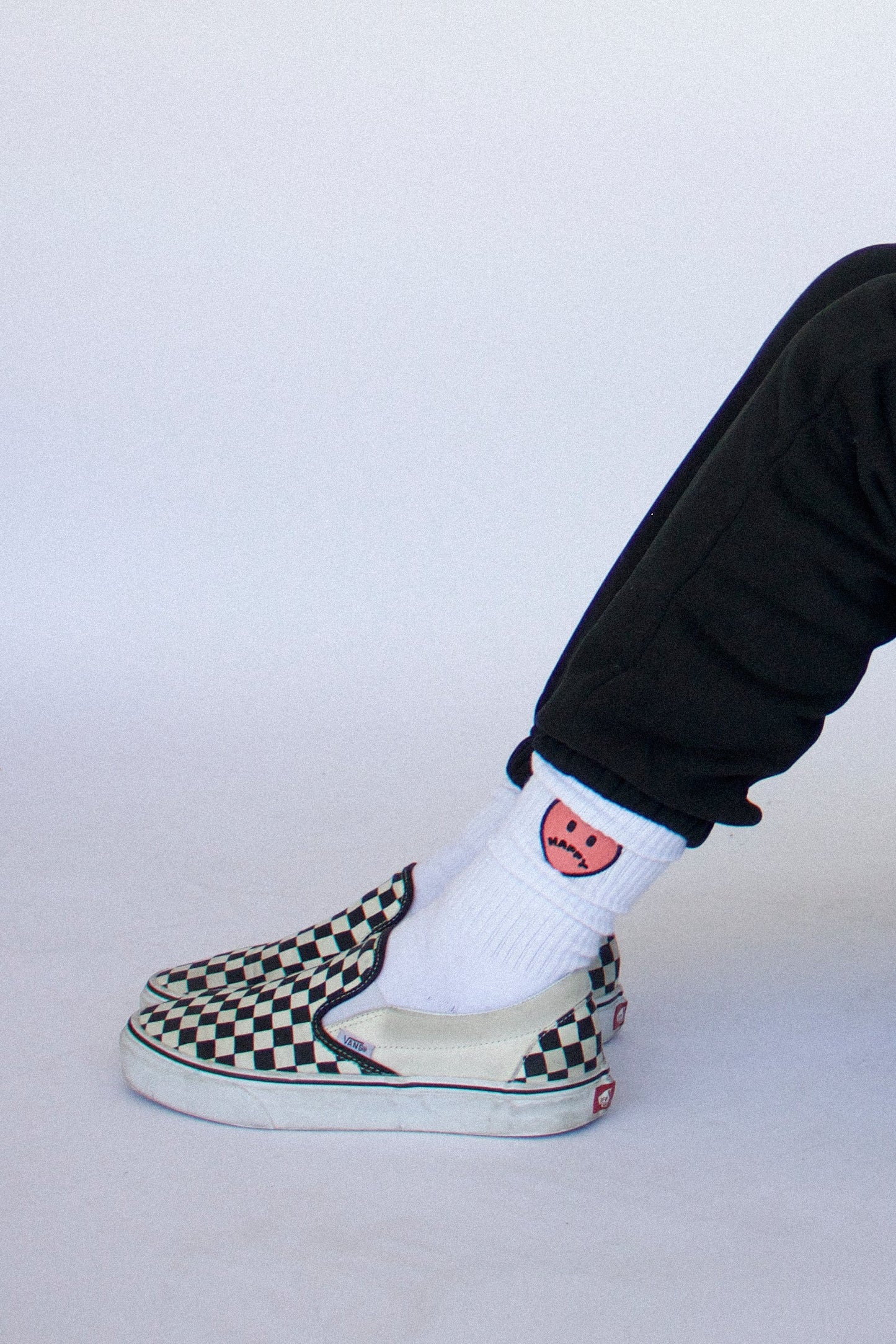 Model wearing Happy Home centerpiece socks — founder-owned streetwear brand