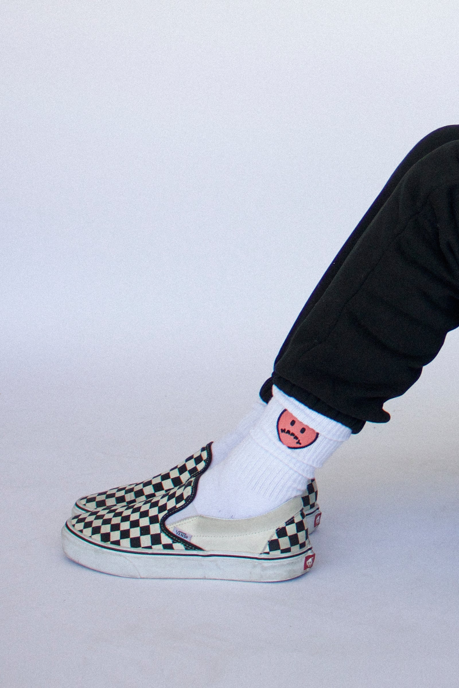 Model wearing Happy Home centerpiece socks — founder-owned streetwear brand
