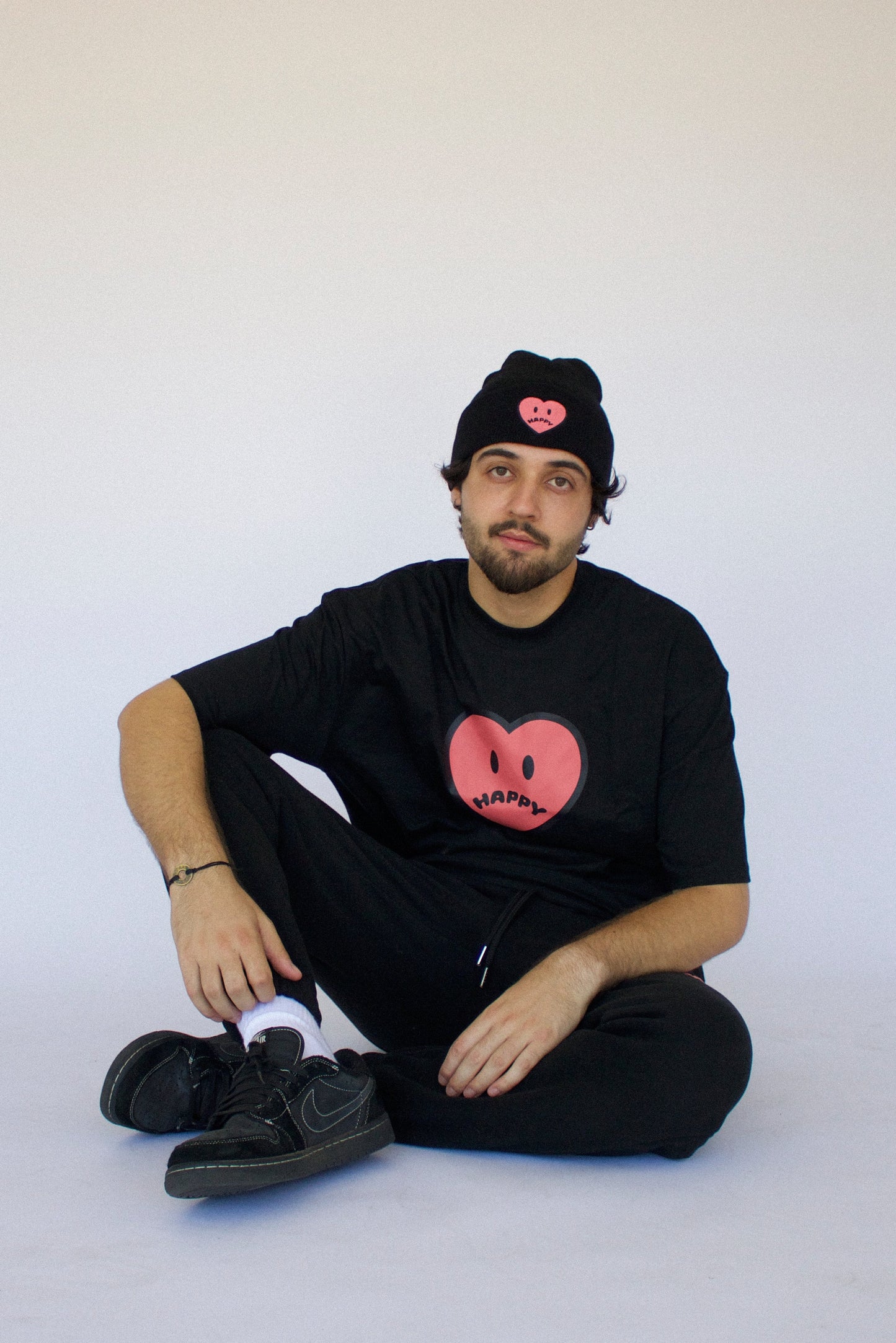 Model wearing Happy Home jet black tee — founder-owned streetwear brand supports NAMI