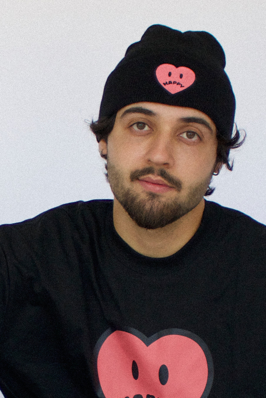Model wearing Happy Home centerpiece beanie — streetwear brand that supports NAMI