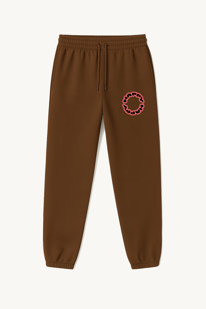Happy Home centerpiece sweatpants chocolate front — globe HAPPY logo, 340 GSM fleece